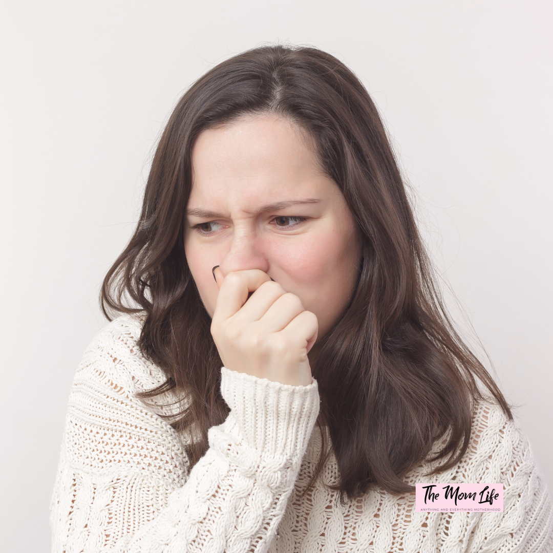 Pregnant Woman Avoiding Strong Smells: Managing Pregnancy Sensitivities