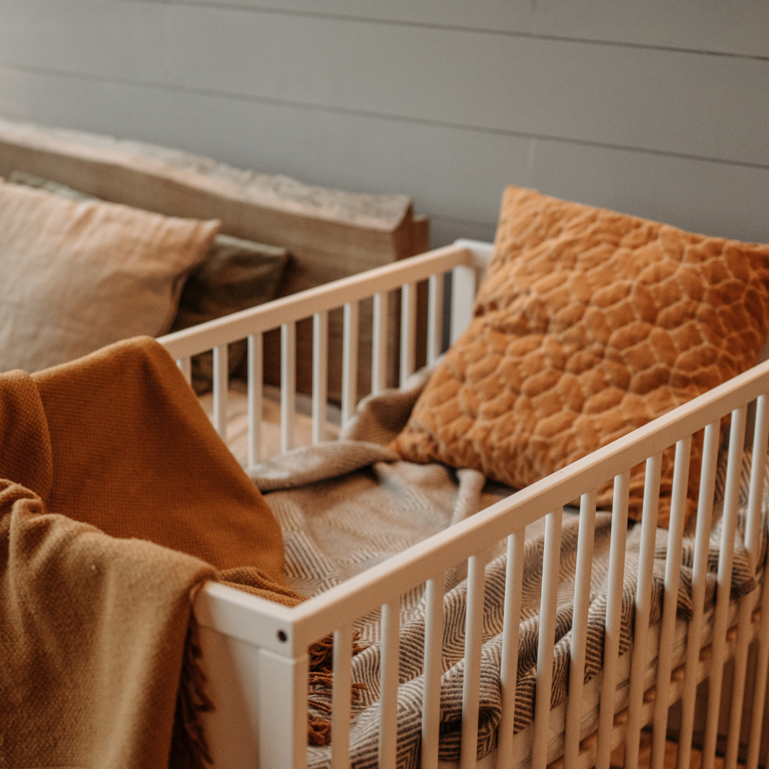 A photo of the crib in the corner of the master bedroom.