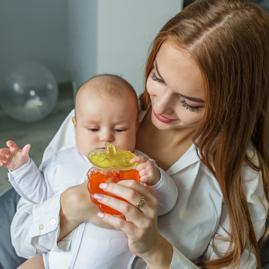 A mother giving her baby a teether 