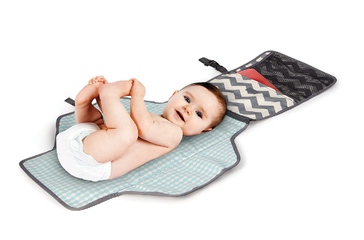 A baby in its portable changing pad 