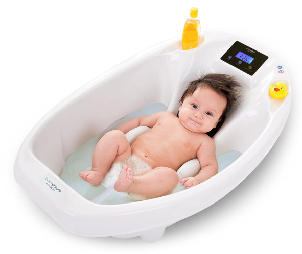 A baby boy lying on its bathtub