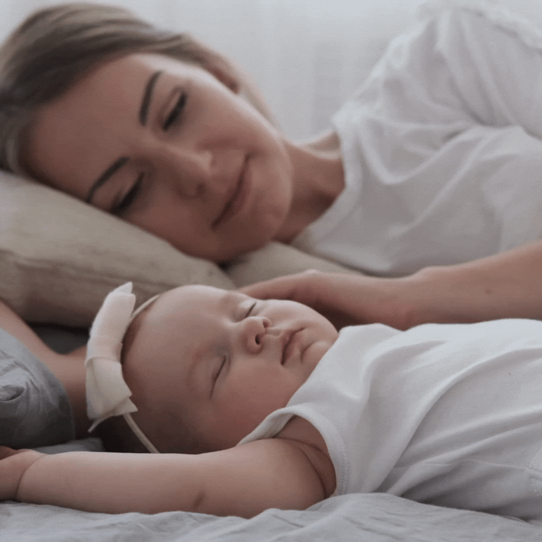 A mother watching her baby sleeping