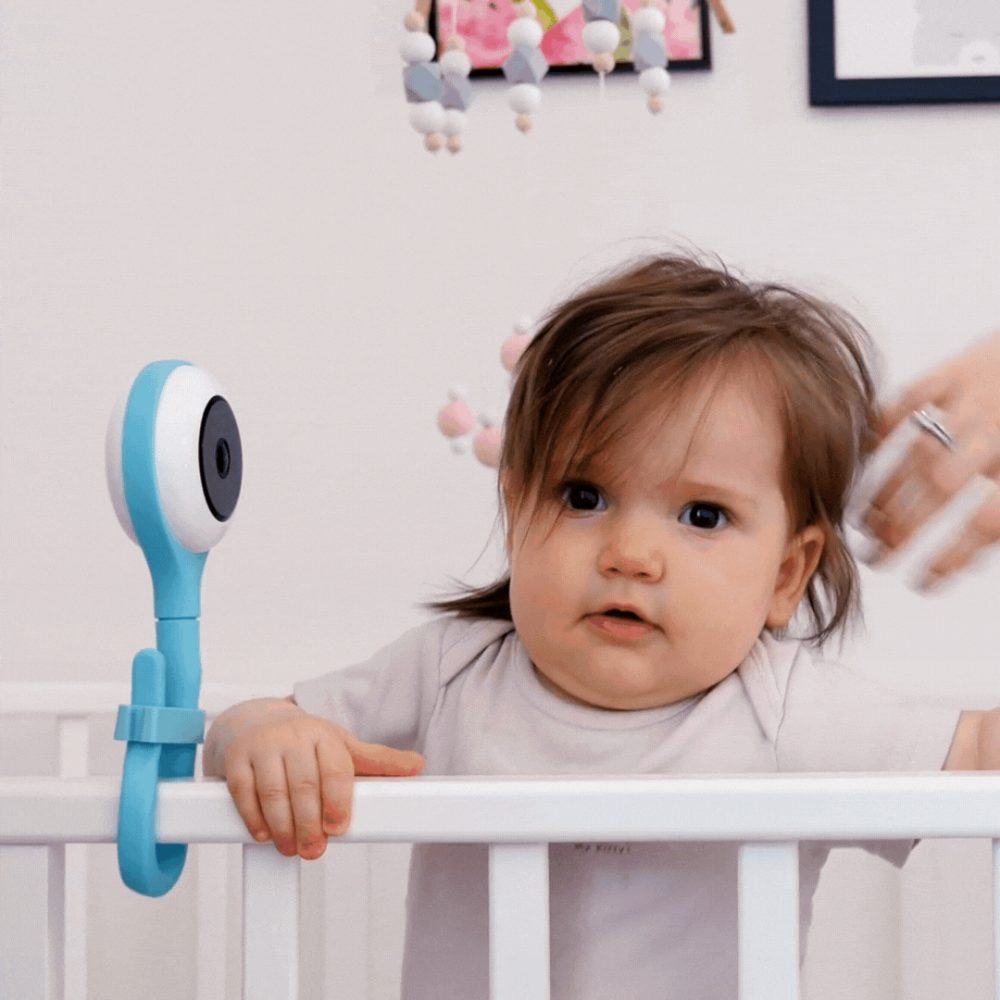 A baby playing on her crib.